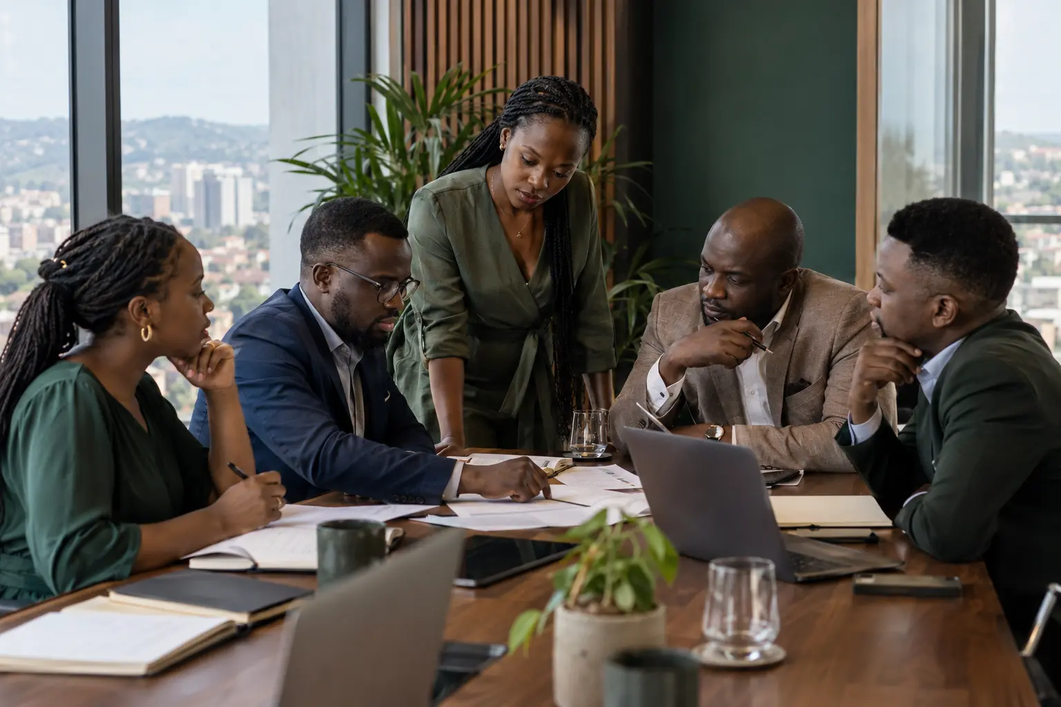 Illustrative image of business professionals collaborating around a meeting table